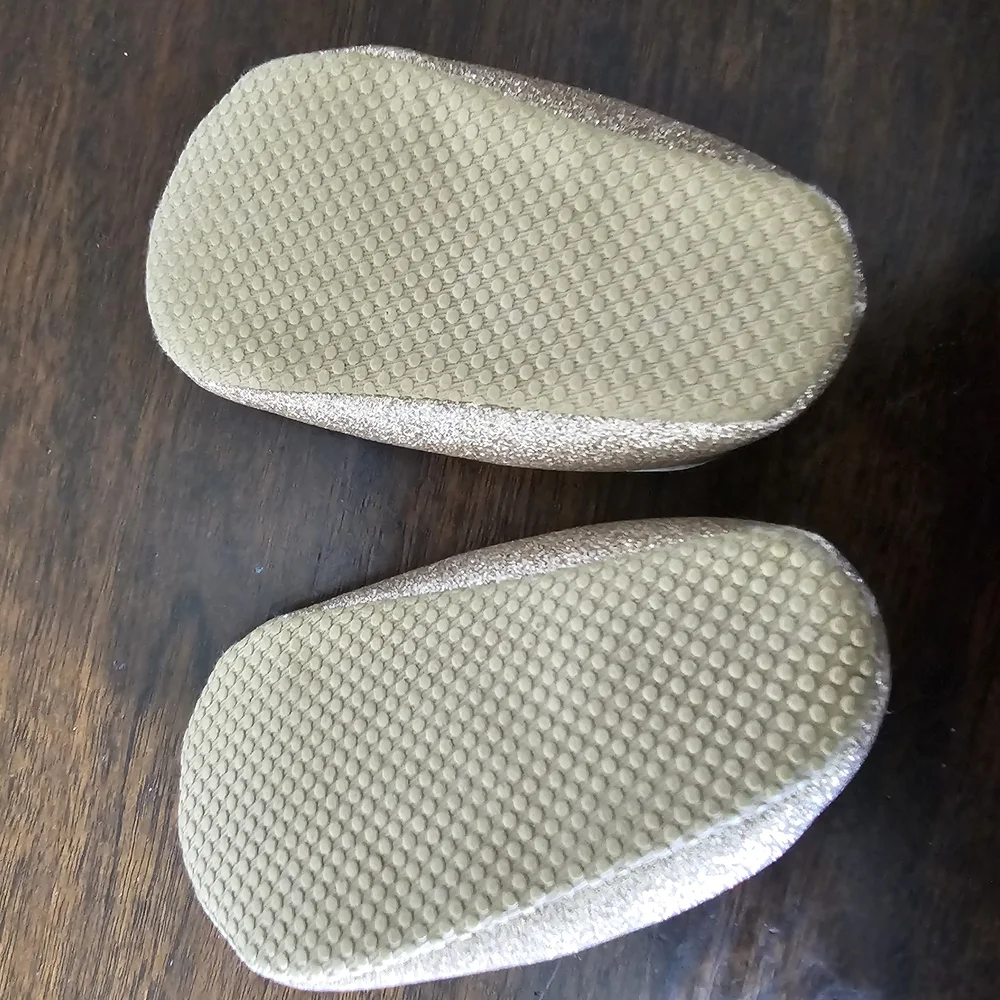 3 pairs of baby/girl shoes—soft, floral, and glittery—in various styles.